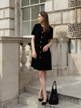 A woman wears a modest triacetate dress